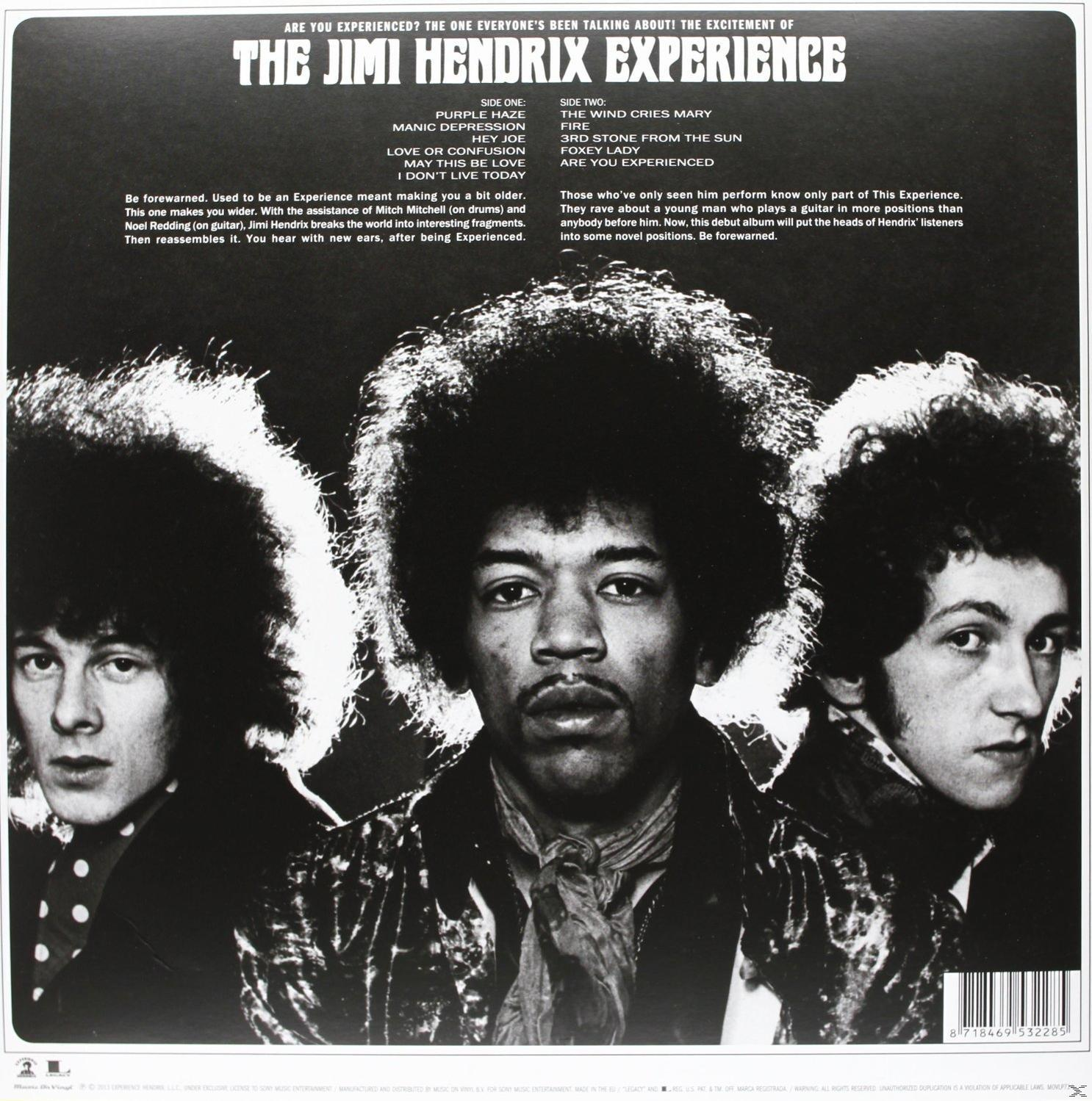 Album back cover. Three men, text listing song titles and credits, black and white.