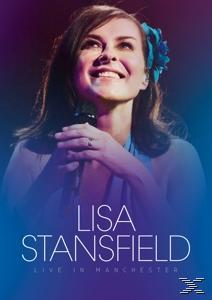 DVD-Cover mit Lisa Stansfield, die lächelt und ein Mikrofon hält. Titel: Live in Manchester.