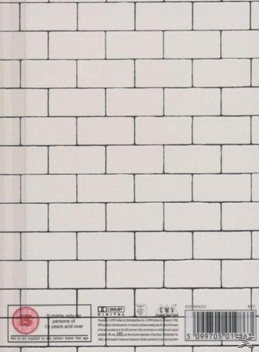 Die Abdeckung ist eine weiße Backsteinmauer. Unten steht Text.