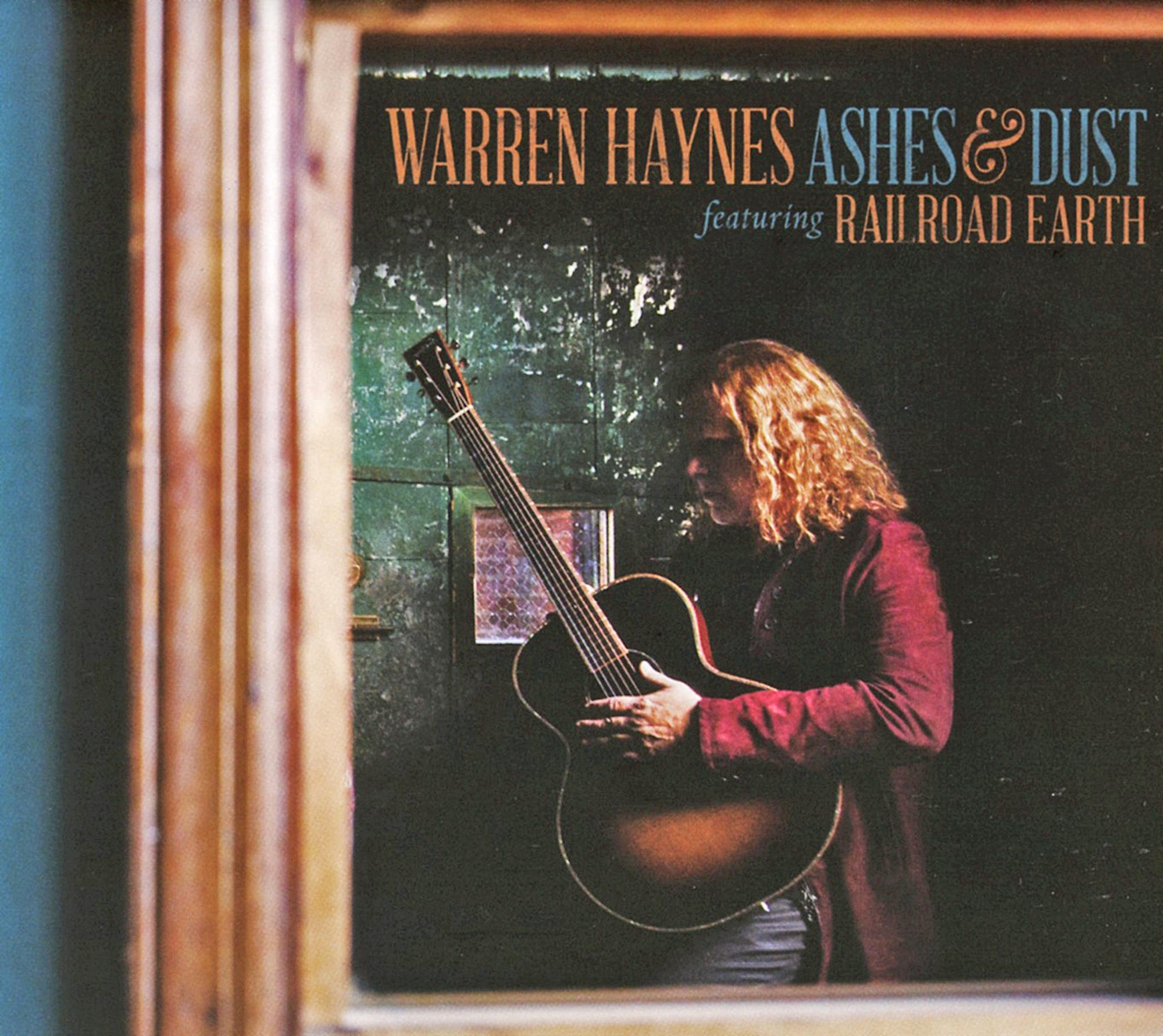 Albumcover mit einem Mann, der Gitarre spielt, vor einem dunkelgrünen Hintergrund.