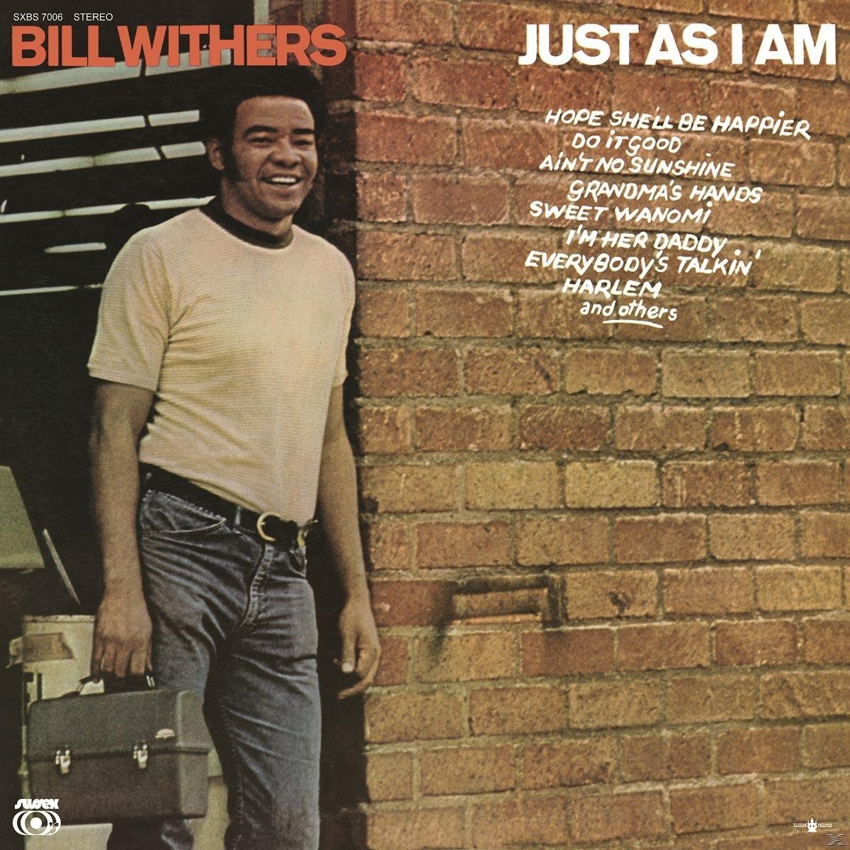 Albumcover mit einem Mann in weißem Hemd und Jeans, der sich an eine Backsteinmauer lehnt.
