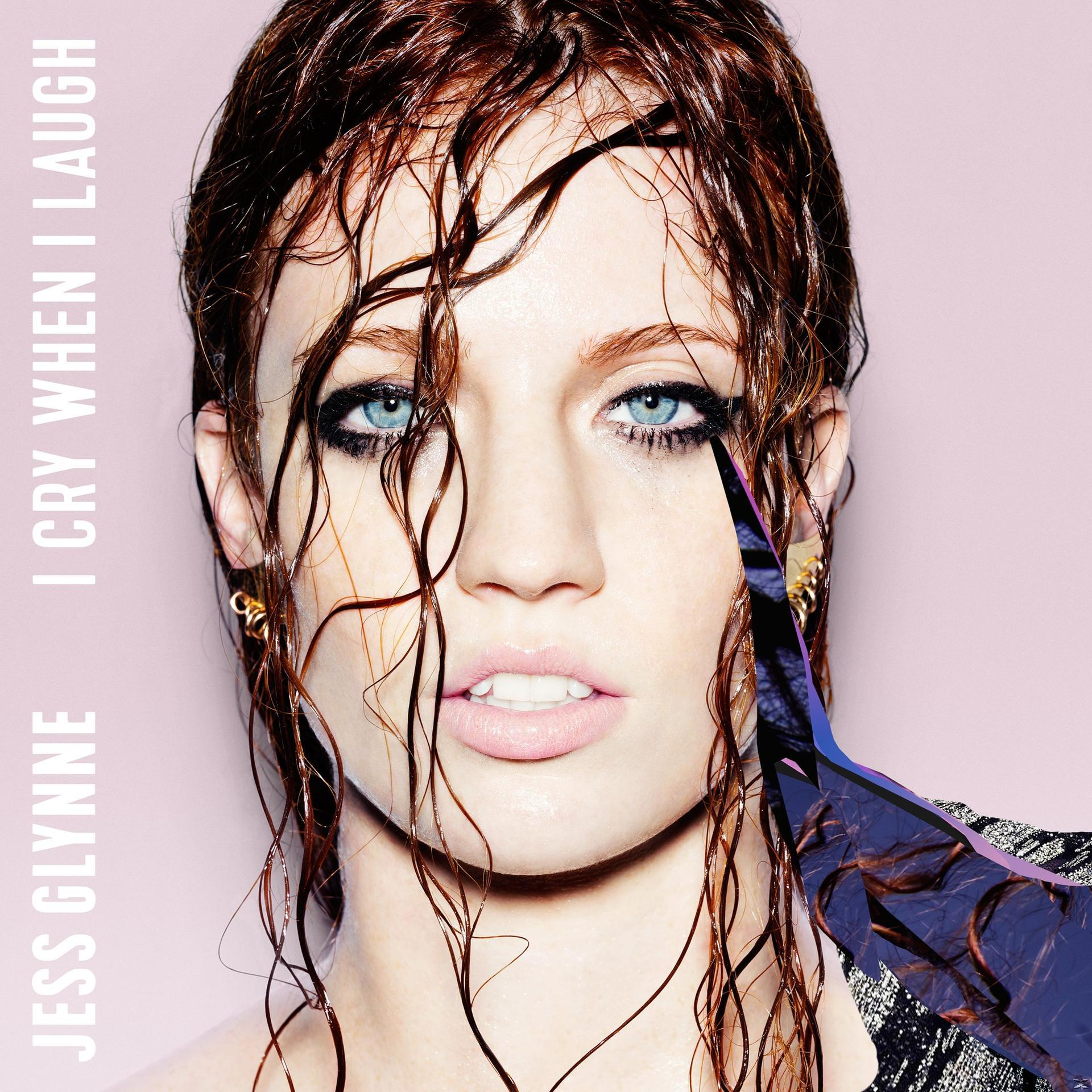 Jess Glynne album borítója. Vizes, vörös haja van, kék szemei, rózsaszín háttér el őtt. A szöveg: "I Cry When I Laugh".