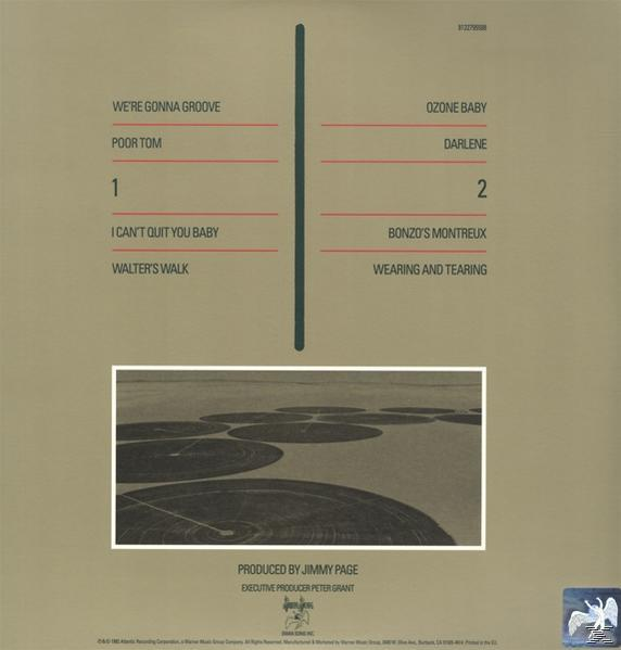 Album-Rückseite mit Trackliste. Brauner Hintergrund mit Linien und einem Landschaftsfoto.