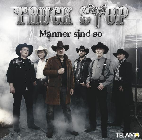 Truck Stop Bandmitglieder posieren. Sie tragen Cowboyhüte und lächeln.