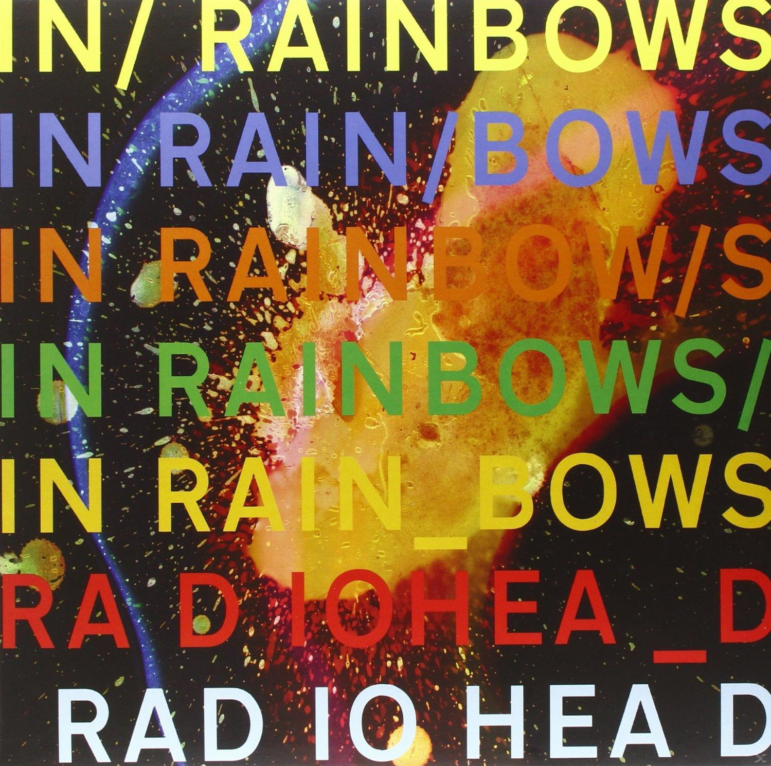 Albumcover mit farbenfrohem Text 'IN RAINBOWS' auf einem gesprenkelten Farbhintergrund, 'RADIOHEAD' unten.