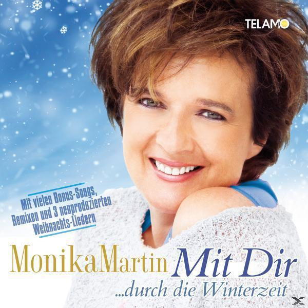 CD-Cover für Monika Martin 'Mit Dir', mit einer Frau in winterlicher Umgebung, Text und Schneeflocken.