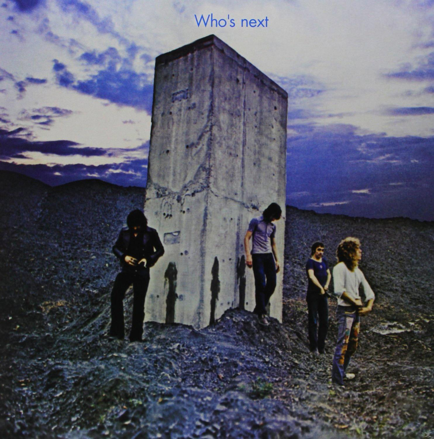 Album borító: A The Who együttes egy betonépület mellett áll egy kopár tájon. Kék ég, szöveg: Who's Next.