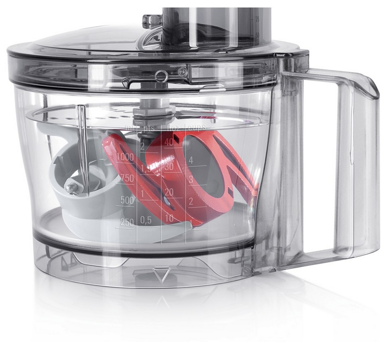 A food processor with a clear container, a red blade, and a white blade.
