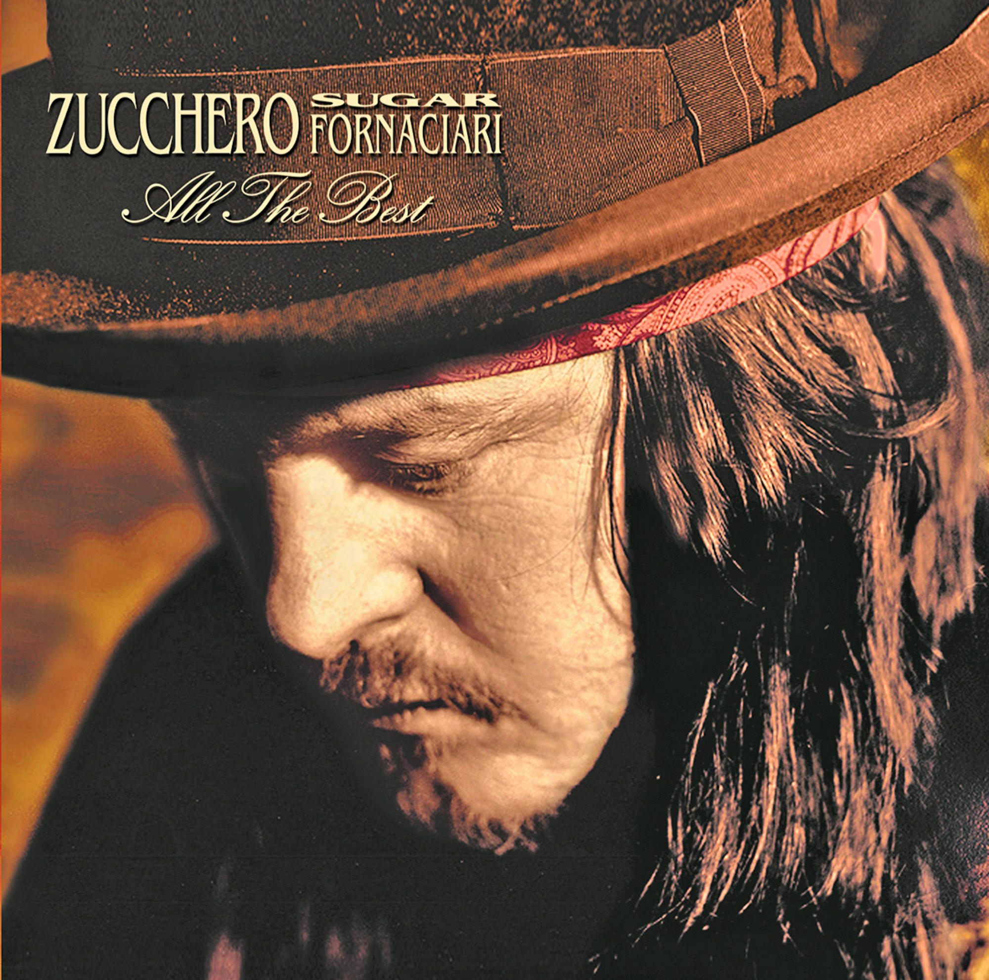 Bild von Zucchero mit Hut und dem Text 'All The Best' auf dem Hut.
