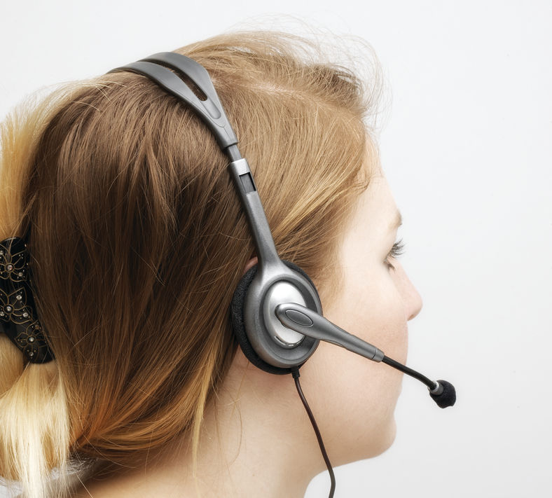 A woman in profile wearing a headset microphone.