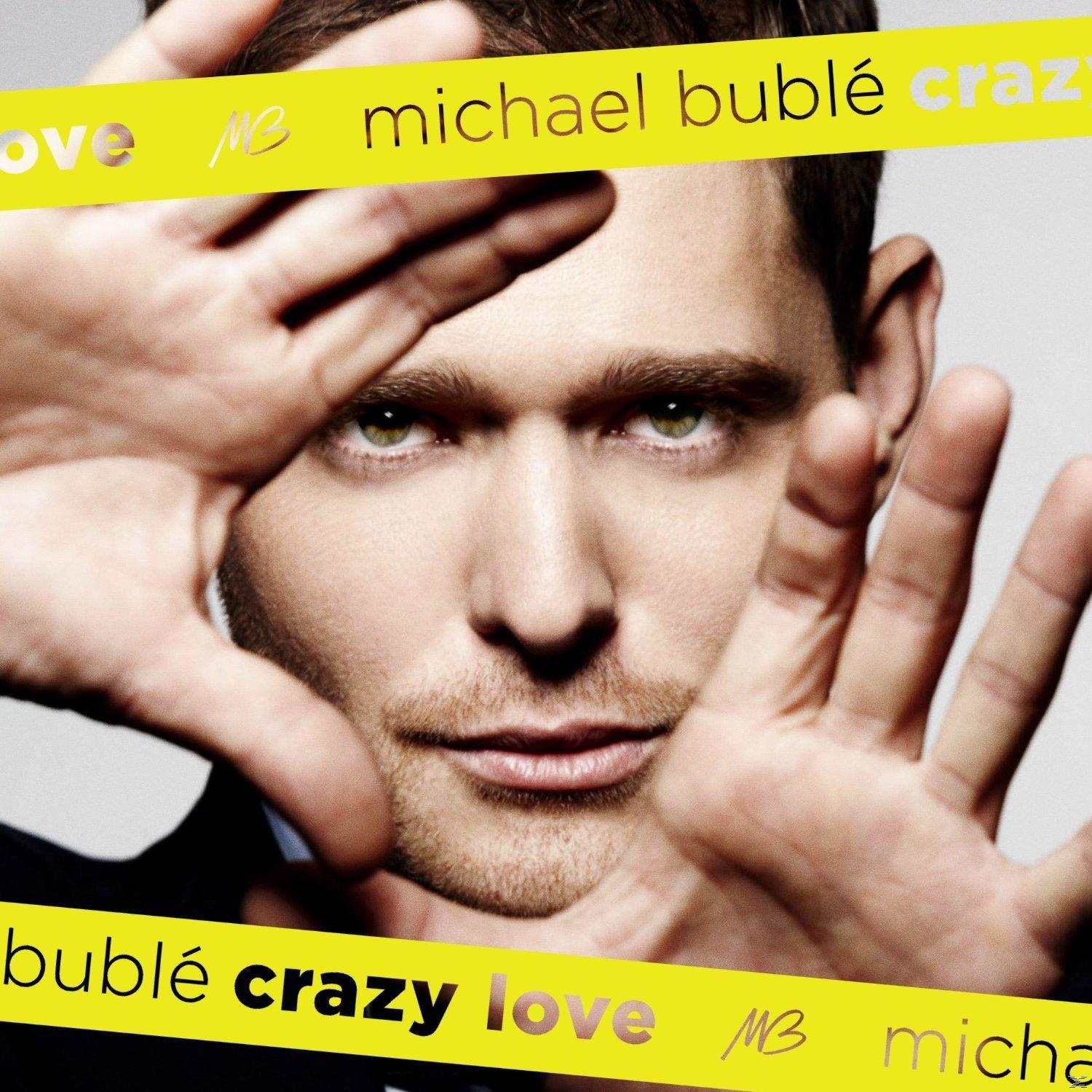 Albumcover: Michael Bublés Gesicht von Händen umrahmt, gelbes Band 'Crazy Love'.