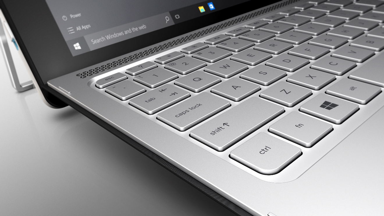 Nahaufnahme einer silbernen Laptop-Tastatur mit Windows-Startmenü auf dem Bildschirm.