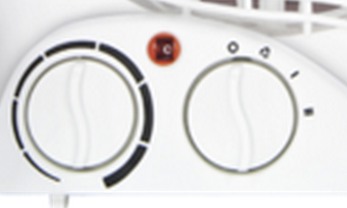 Close-up of a white appliance with two circular dials and a red light in the center.