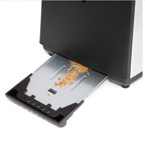 Ein Toaster mit herausgezogener Krümelschublade, die Krümel enthält.