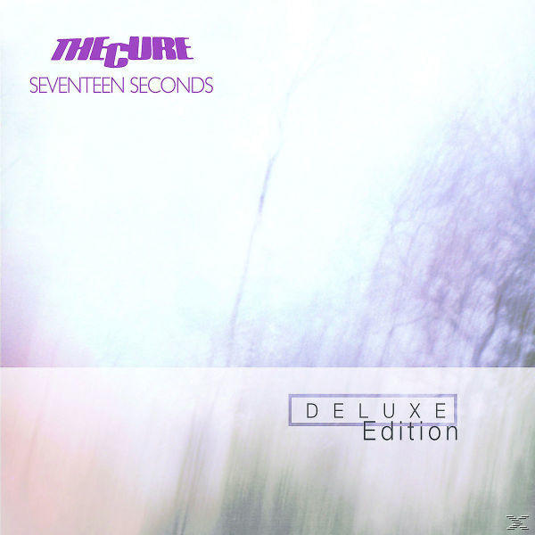 Albumcover: The Cure, Albumtitel "Seventeen Seconds" in lila Buchstaben, mit verschwommenem Hintergrund.