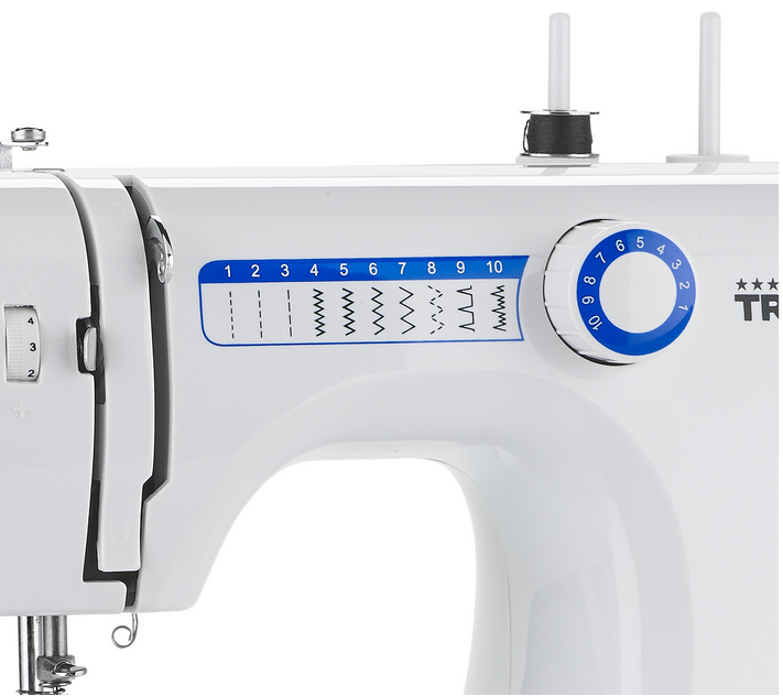 Close up of a white sewing machine. A blue dial with stitches is visible.