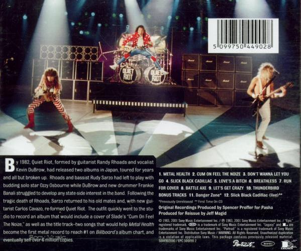 Rückseite des Quiet Riot Albums. Band auf der Bühne. Titelliste und Text.