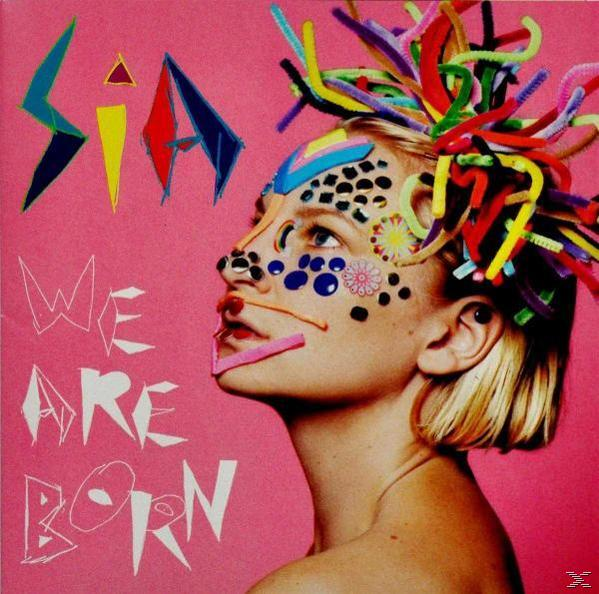 Sia Albumcover: Frau mit farbenfroher Gesichtskunst und Haaren, rosa Hintergrund, Text.