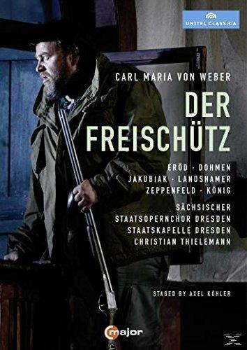 DVD-Cover eines Mannes in einem Mantel, der eine Waffe hält. Text auf Deutsch.