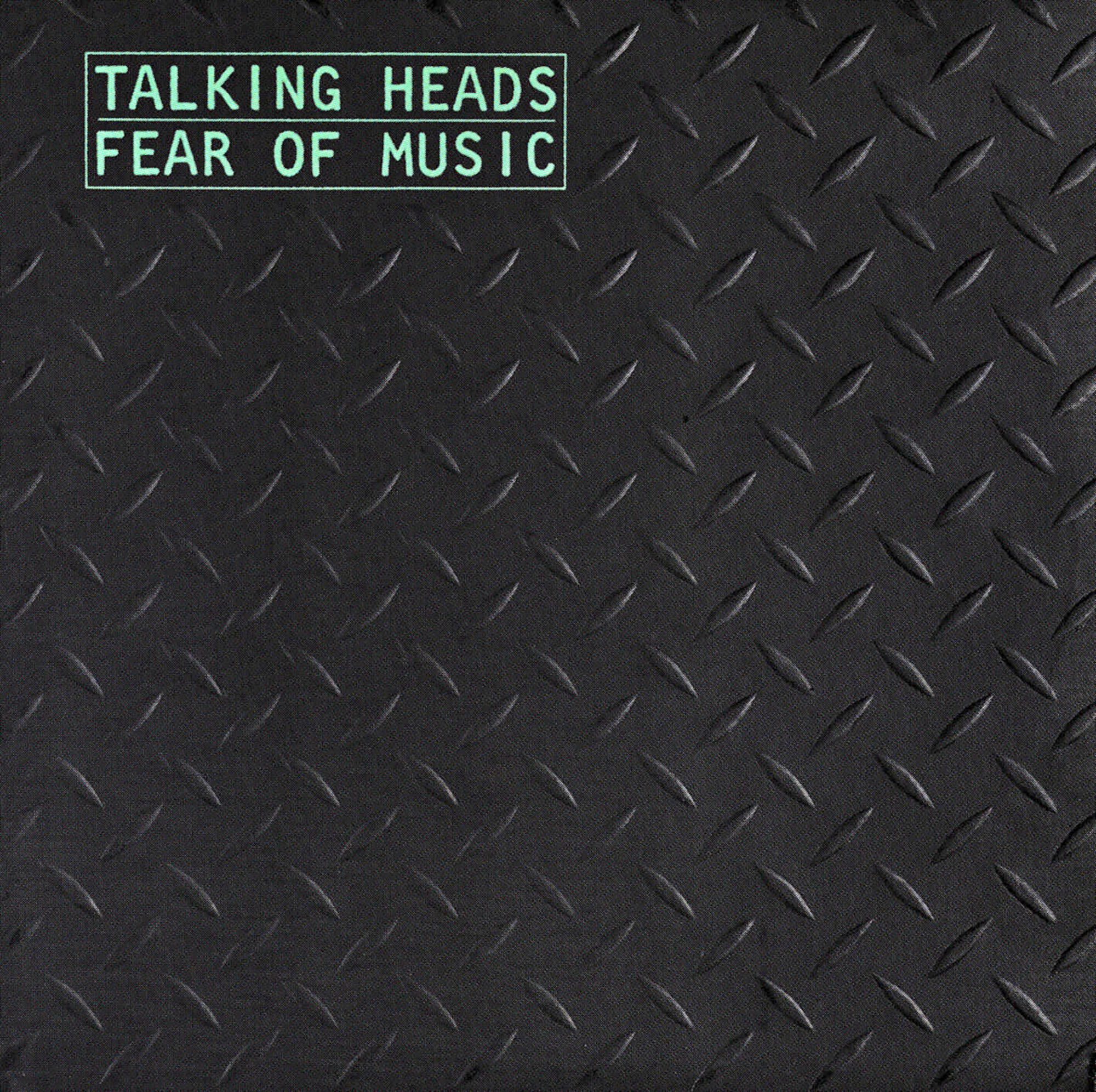 Albumcover mit schwarzem Riffelblechmuster. Text 'Talking Heads - Fear of Music' oben.