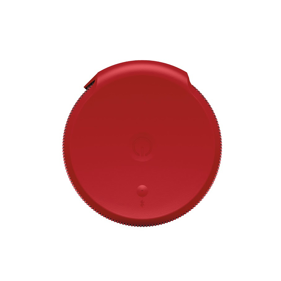 Roter, kreisförmiger Lautsprecherdeckel. Ein-/Aus-Taste und Anschlüsse sichtbar. Weißer Hintergrund.