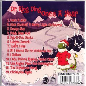 Album-Rückseite: Weihnachtliches Artwork mit Titelliste, eine Cartoon-Eidechse mit Weihnachtsmütze.