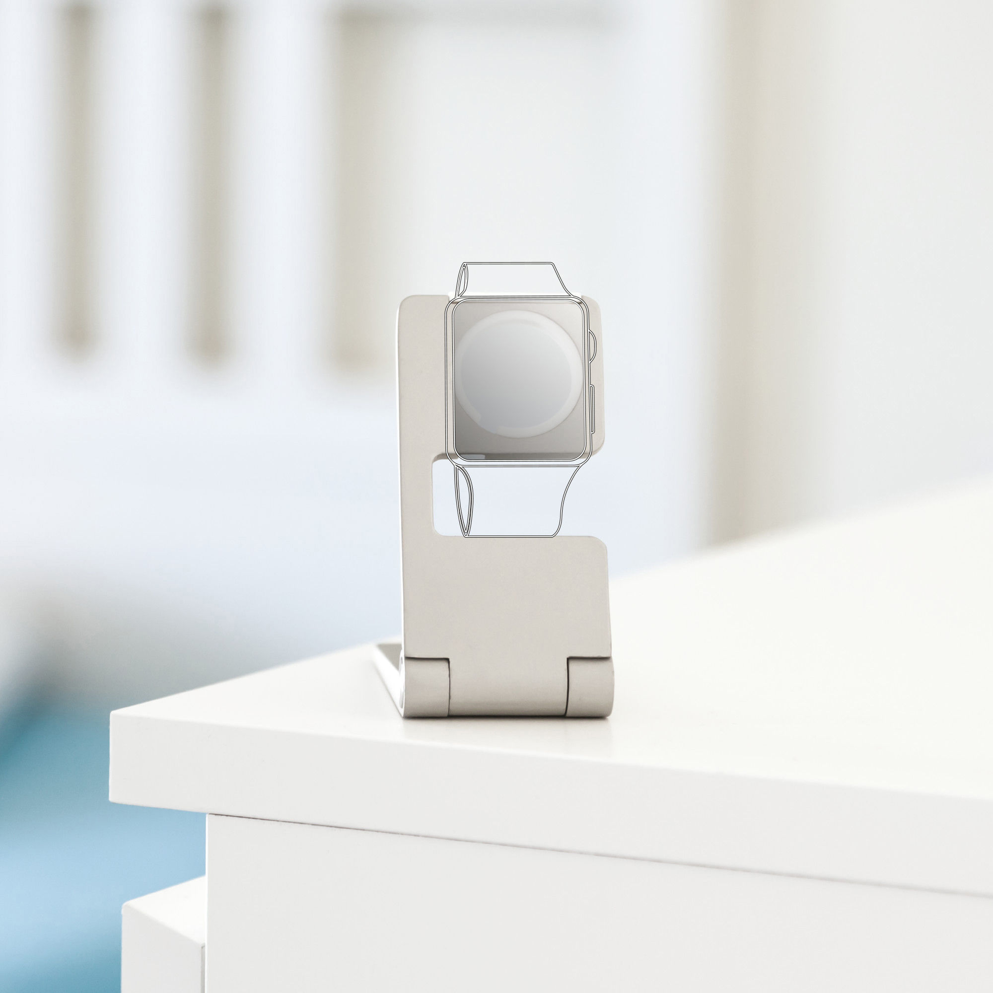 Apple Watch auf einem Ständer, weißer Tisch. Die Uhr ist in Umrissform dargestellt.