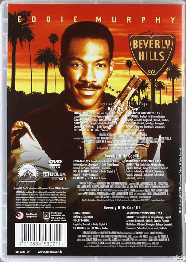 DVD-Cover von Beverly Hills Cop, mit Eddie Murphy, der eine Waffe hält. Der Hintergrund ist ein Stadtblick.