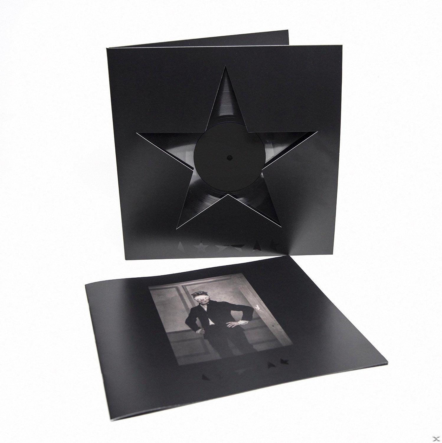 Zwarte vinylplaat in een ster-vormige uitgesneden hoes. De hoes heeft een afbeelding van een man.