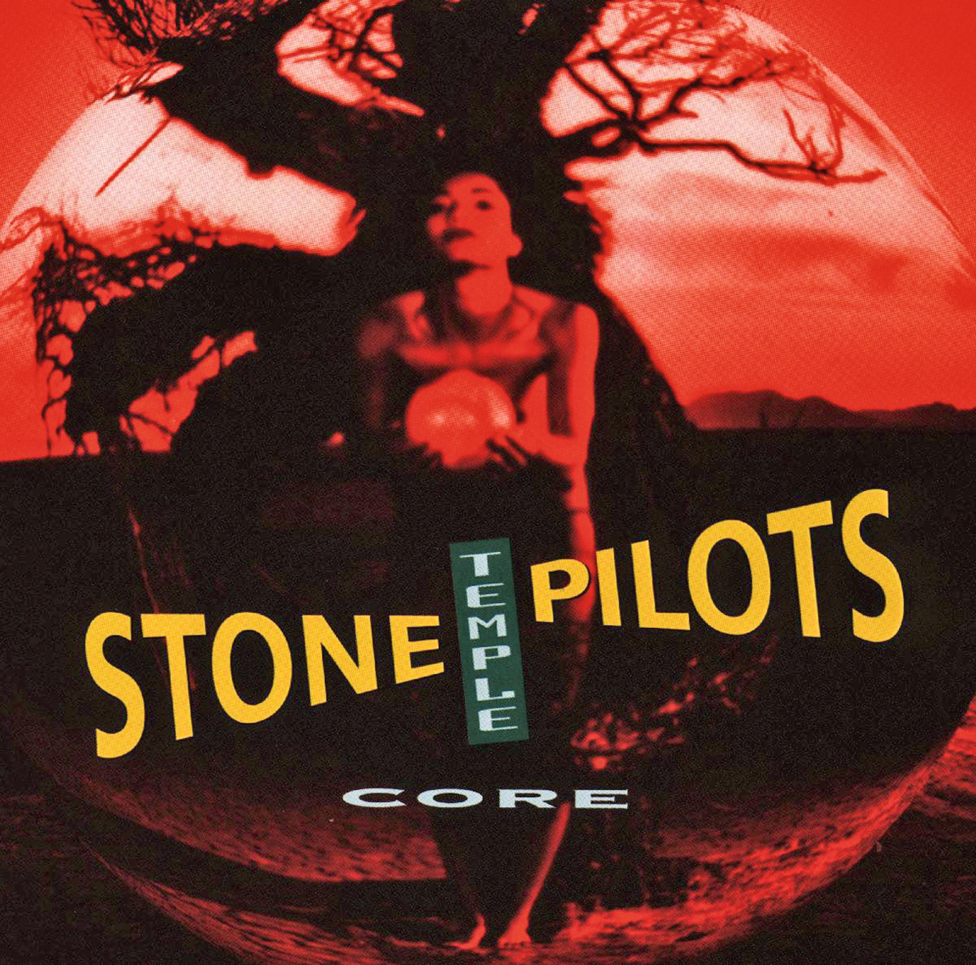 Albumcover: Stone Temple Pilots - Core. Eine Frau mit einem Ball vor verschwommenem roten Hintergrund.