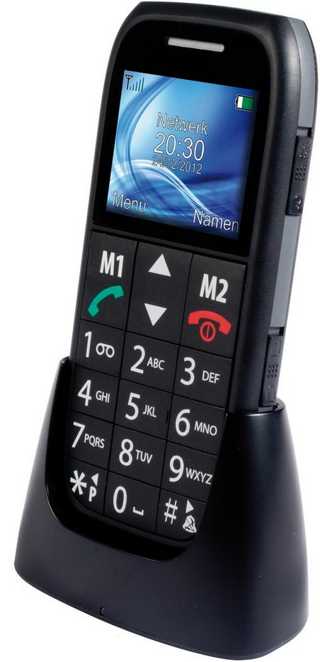 Téléphone portable noir dans un socle noir. Il affiche l'heure et la date. Il a de gros boutons et un écran bleu.