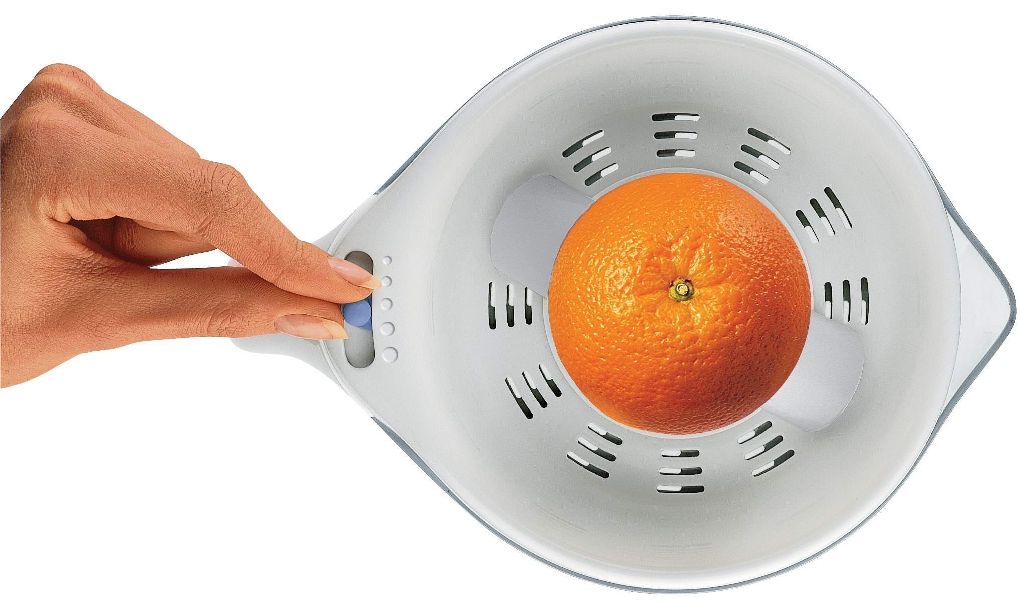 A hand presses a blue button on a juicer with an orange.