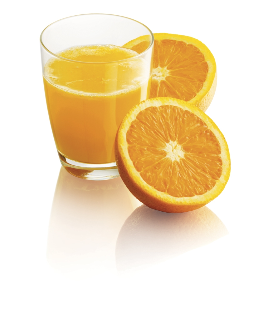 A glass of orange juice with two orange slices beside it.