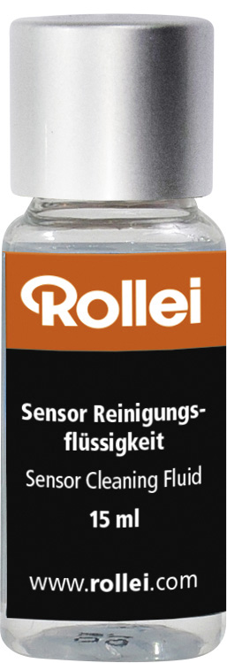 Kleine Flasche Reinigungsflüssigkeit mit silbernem Deckel und orange/schwarzem Etikett. Weißer Hintergrund.