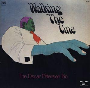 Albumcover mit einem illustrierten Mann mit grüner Haut und einer großen Hand, betitelt "Walking The Line".