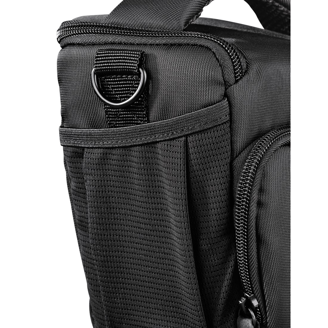 Close up of a black camera bag with a metal ring and zipper details.