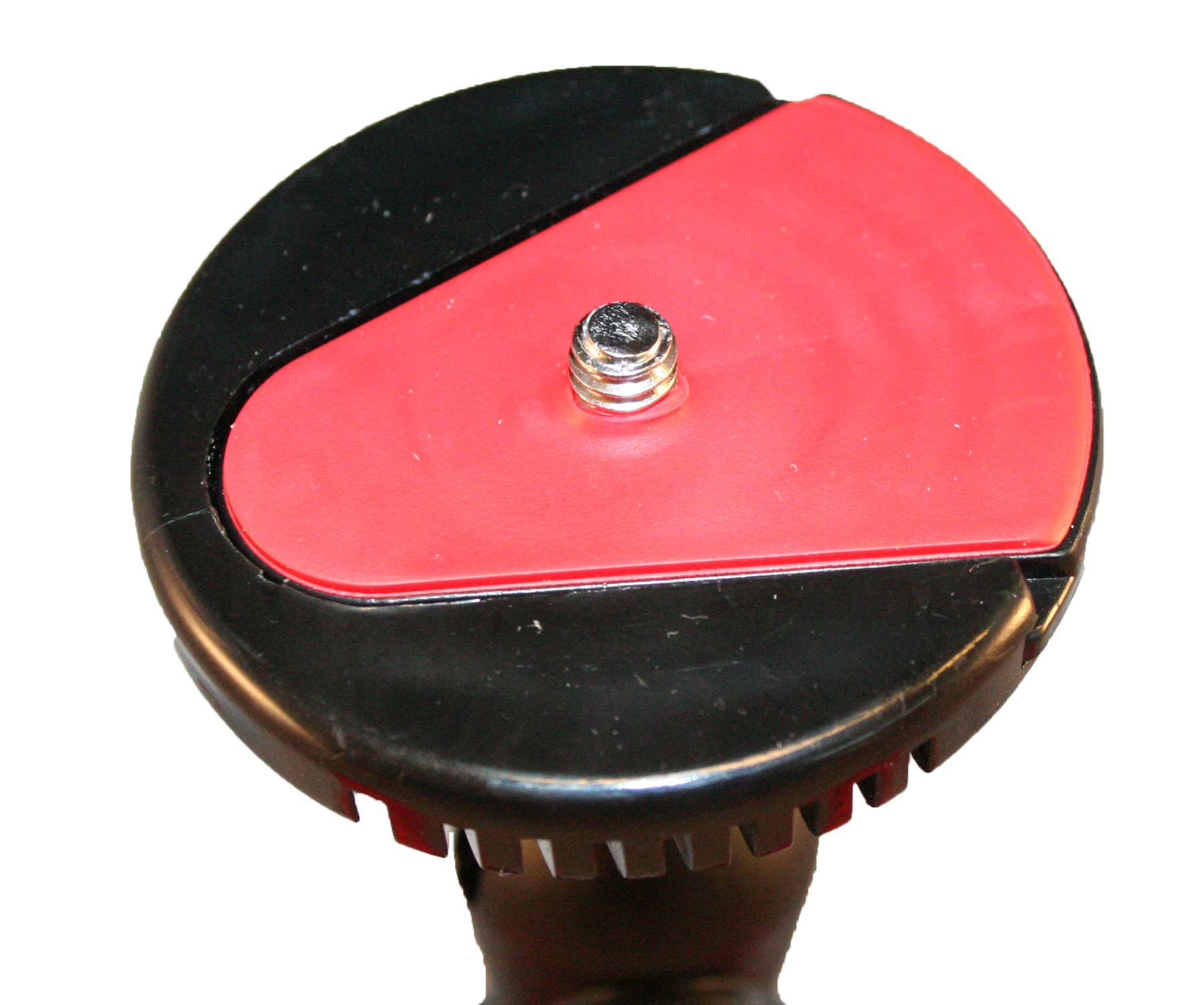 Close up of a black tripod head with a red plate and a screw.