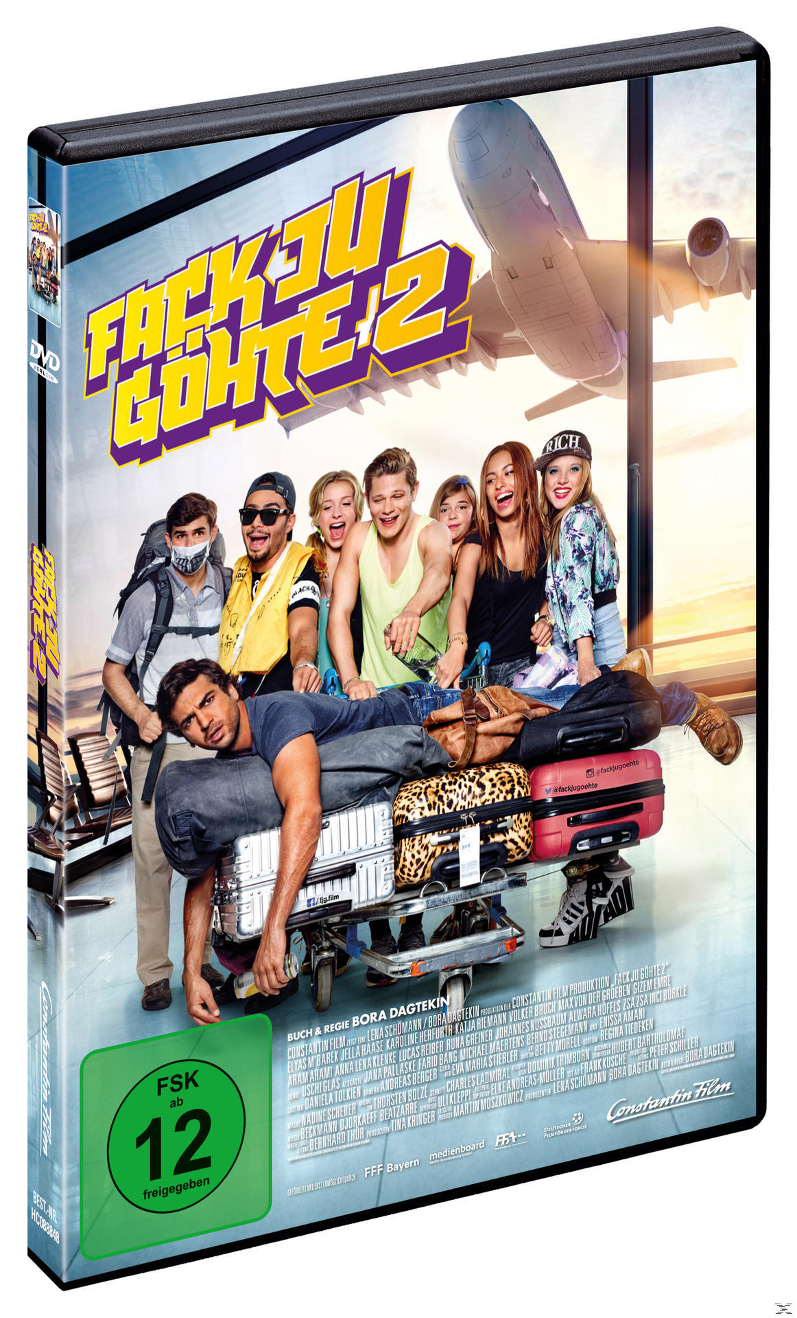 DVD-Cover mit Schauspielern und Text. Ein Mann liegt auf Gepäck auf einem Wagen.