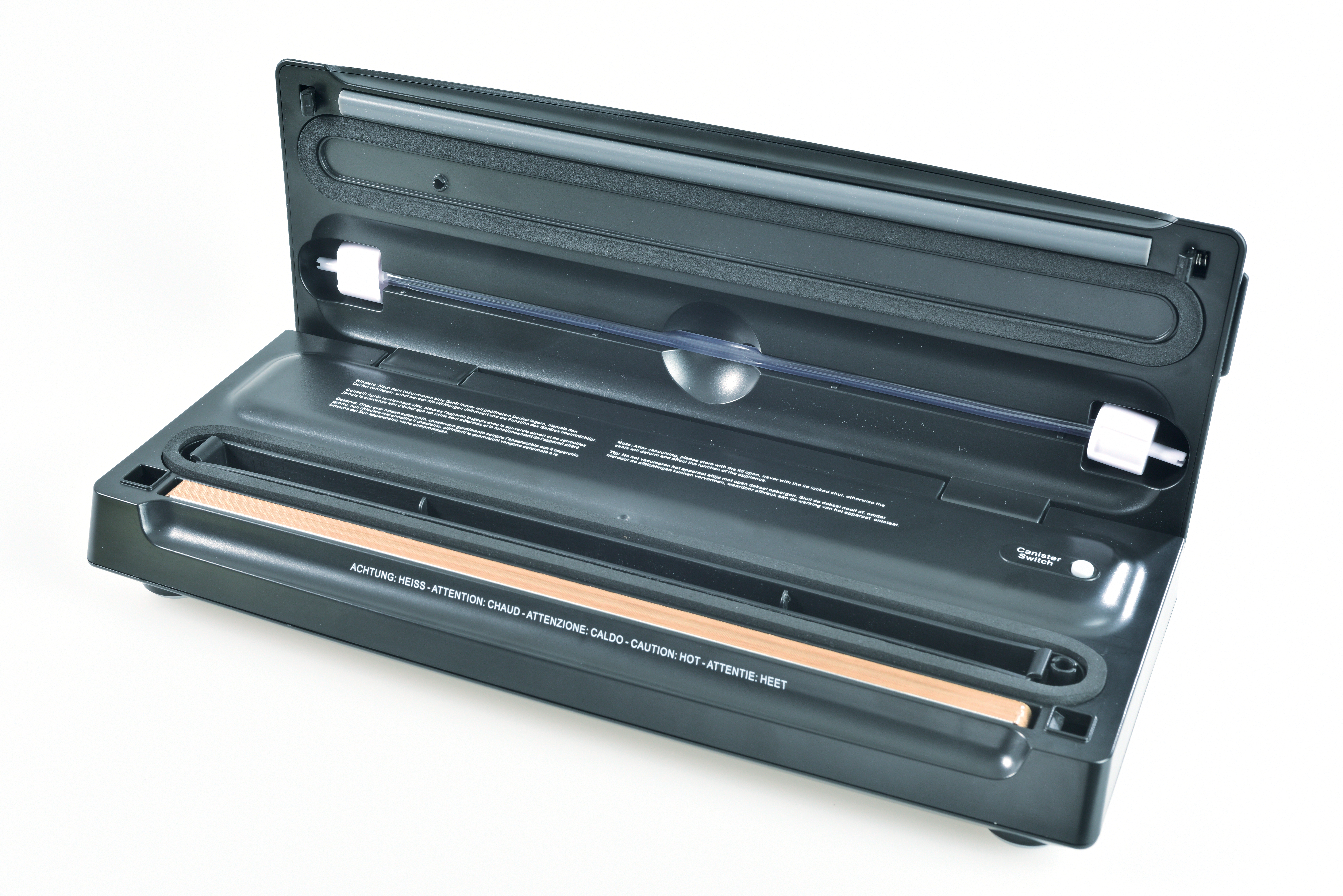 A black vacuum sealer is open, showing a heating element and a clear tube. The device has warning labels in multiple languages.