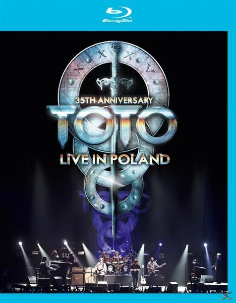 Blu-ray-Cover eines Konzerts von Toto mit der Band auf der Bühne.