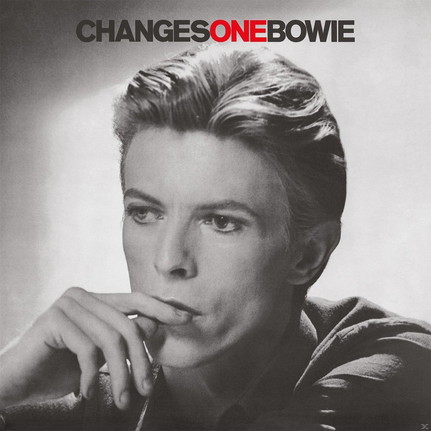 Fekete-fehér fotó David Bowie-ról, aki gondolkodónak tűnik, a CHANGESONEBOWIE szöveggel felül.