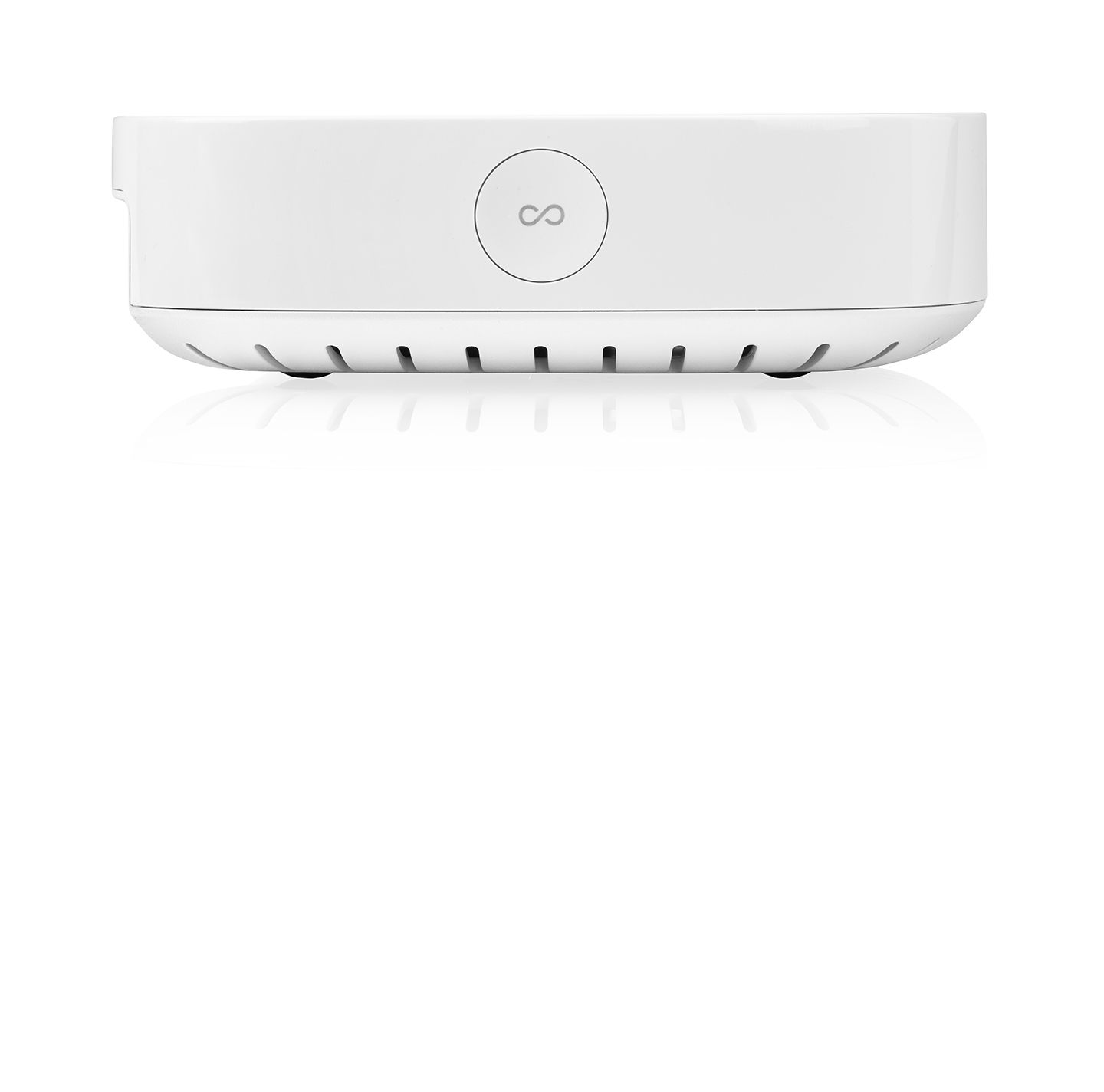 Un appareil blanc avec le symbole de l'infini. Il possède de petites fentes d'aération et est posé sur une surface.