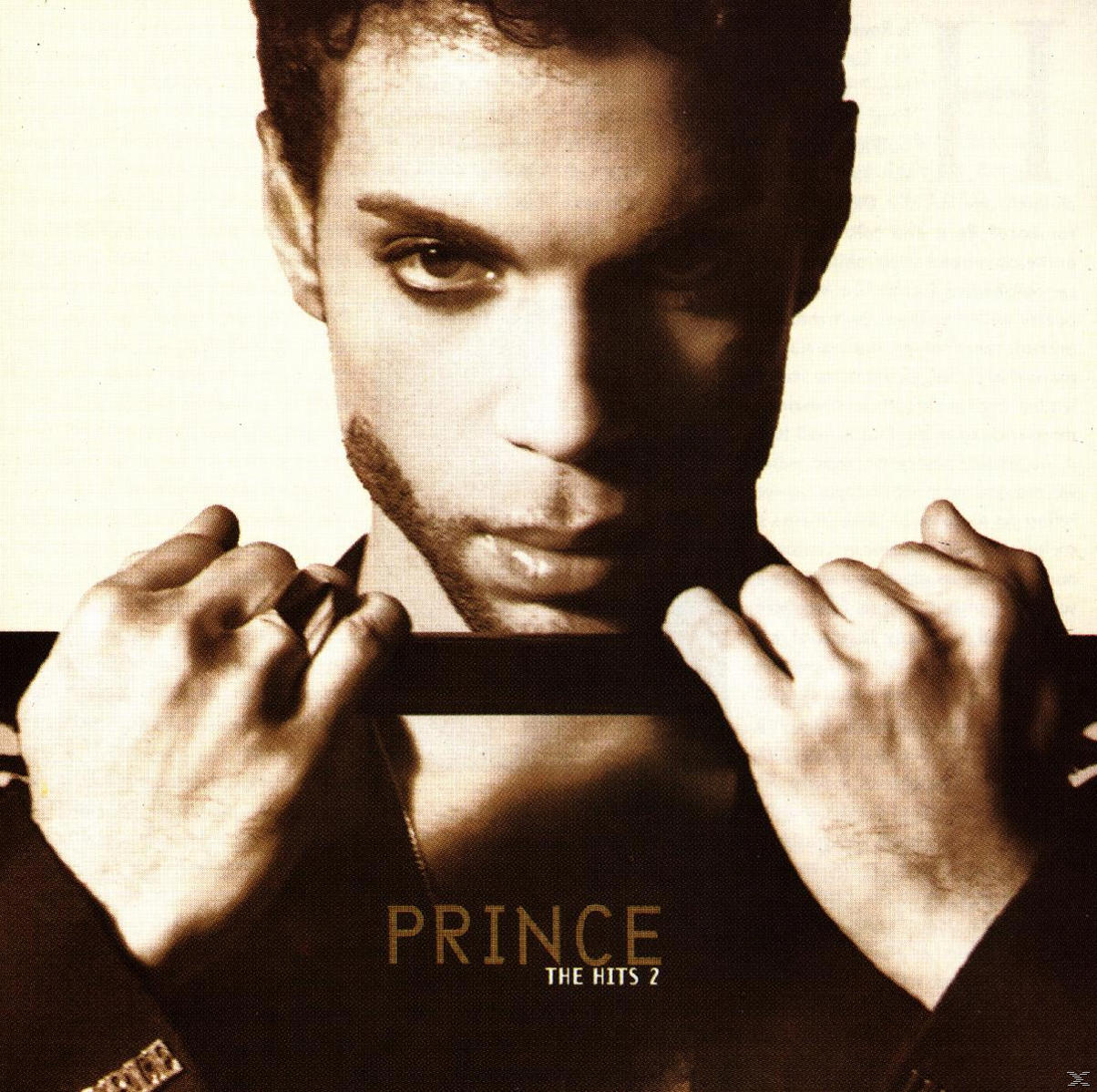 Album cover of Prince. His face is close up, with a dark background.