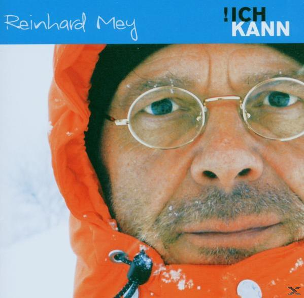 Nahaufnahme von Reinhard Mey auf einem CD-Cover mit Brille und orangefarbener Jacke.