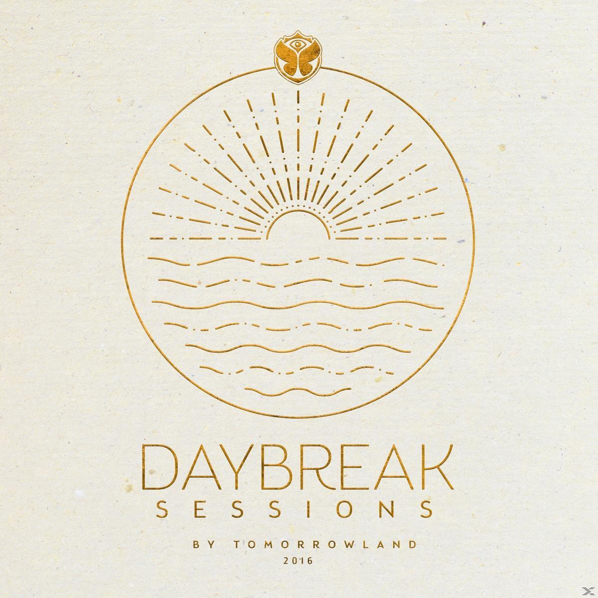 Gouden logo op beige. Cirkel met zon, golven en tekst 'DAYBREAK SESSIONS'. 'Tomorrowland 2016' onderaan.