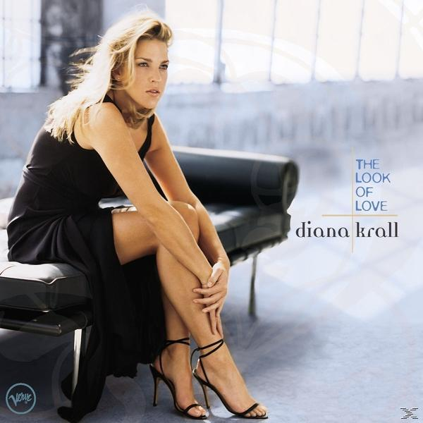 Diana Krall Albumcover. Sie trägt ein schwarzes Kleid und sitzt auf einer dunklen Couch. Blauer Hintergrund.