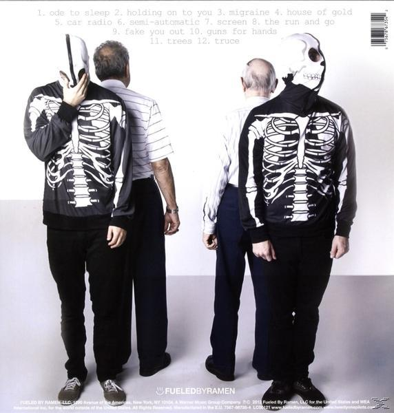Rückseite eines Albums mit zwei Personen in Skelettanzügen und Masken. Andere Personen im Hintergrund.