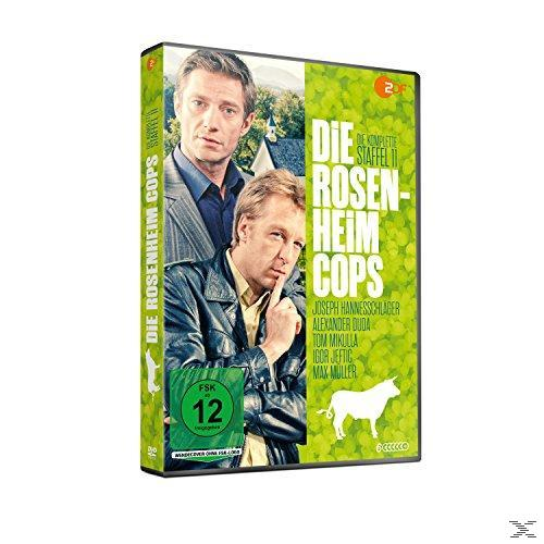 DVD-Cover der Serie 'Die Rosenheim Cops' mit zwei Männern in Anzügen auf grünem Hintergrund.