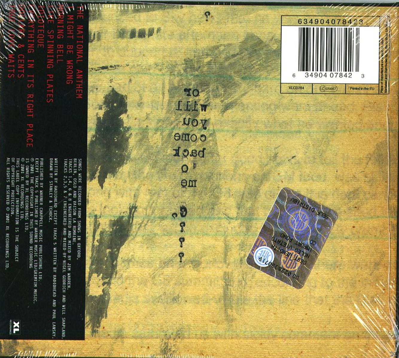 Albumcover mit einer Liste von Songs und Text. Der Hintergrund ist gelb. Ein Sicherheitsaufkleber ist sichtbar.