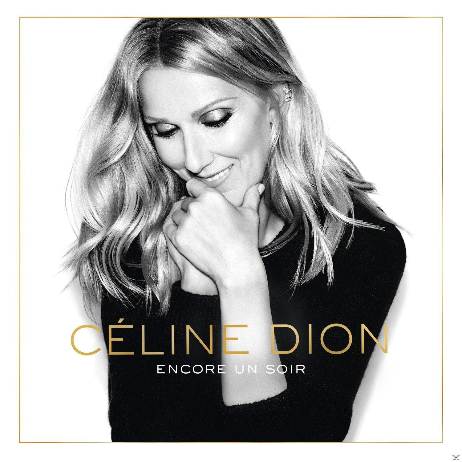 Celine Dion album borítója. Közelkép Celine Dionról, aki lefelé néz. Arany szöveg fehér háttéren.